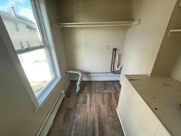 a view of a bathroom with a sink and wooden floor