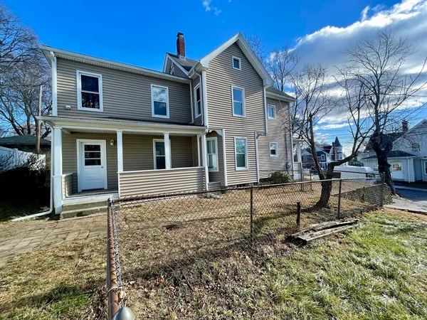 a house that has a wooden bench in front of it