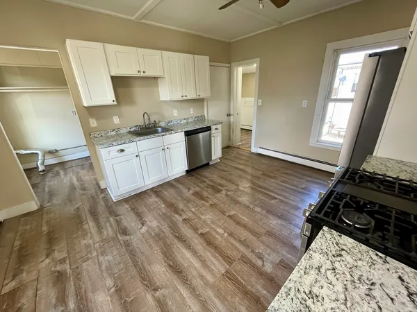 a kitchen with a sink stove and cabinets