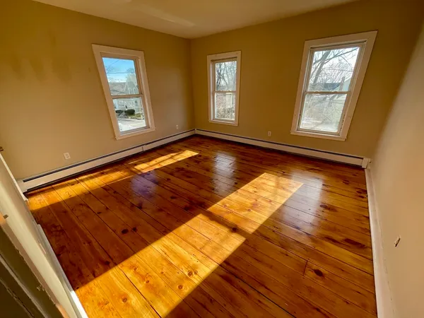 a view of an empty room and wooden floor