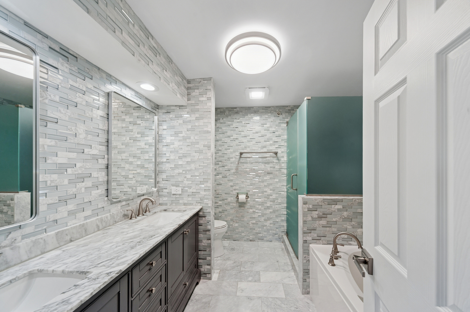 1772 Lancaster Way Northbrook, IL 60062 - Photo 13 of 26 a bathroom with a granite countertop sink a mirror and shower