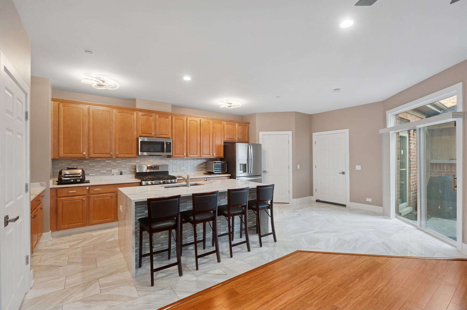 1772 Lancaster Way Northbrook, IL 60062 - Photo 3 of 26 a large kitchen with kitchen island a sink table and chairs