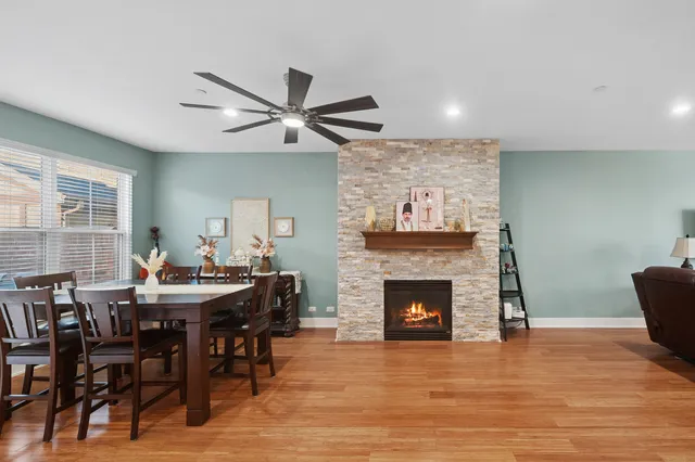 a view of a a dining room with furniture window and wooden floor