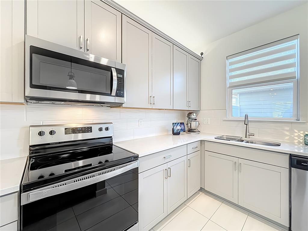 10976 Leafshore Loop Orlando, FL 32829 - Photo 24 of 70 a kitchen with cabinets stainless steel appliances and sink