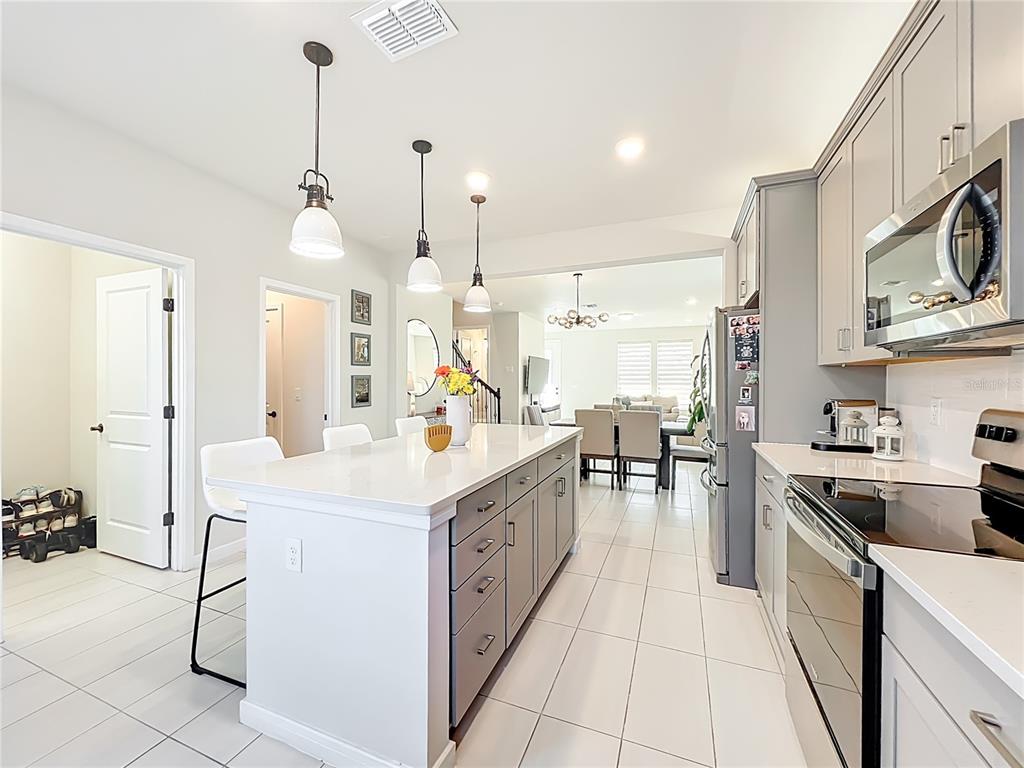 10976 Leafshore Loop Orlando, FL 32829 - Photo 26 of 70 a kitchen with a sink a counter top space appliances and cabinets