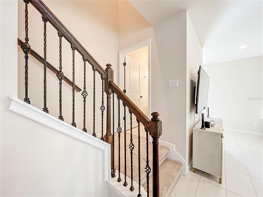 10976 Leafshore Loop Orlando, FL 32829 - Photo 30 of 70 a view of staircase with lots of frames on wall and a window