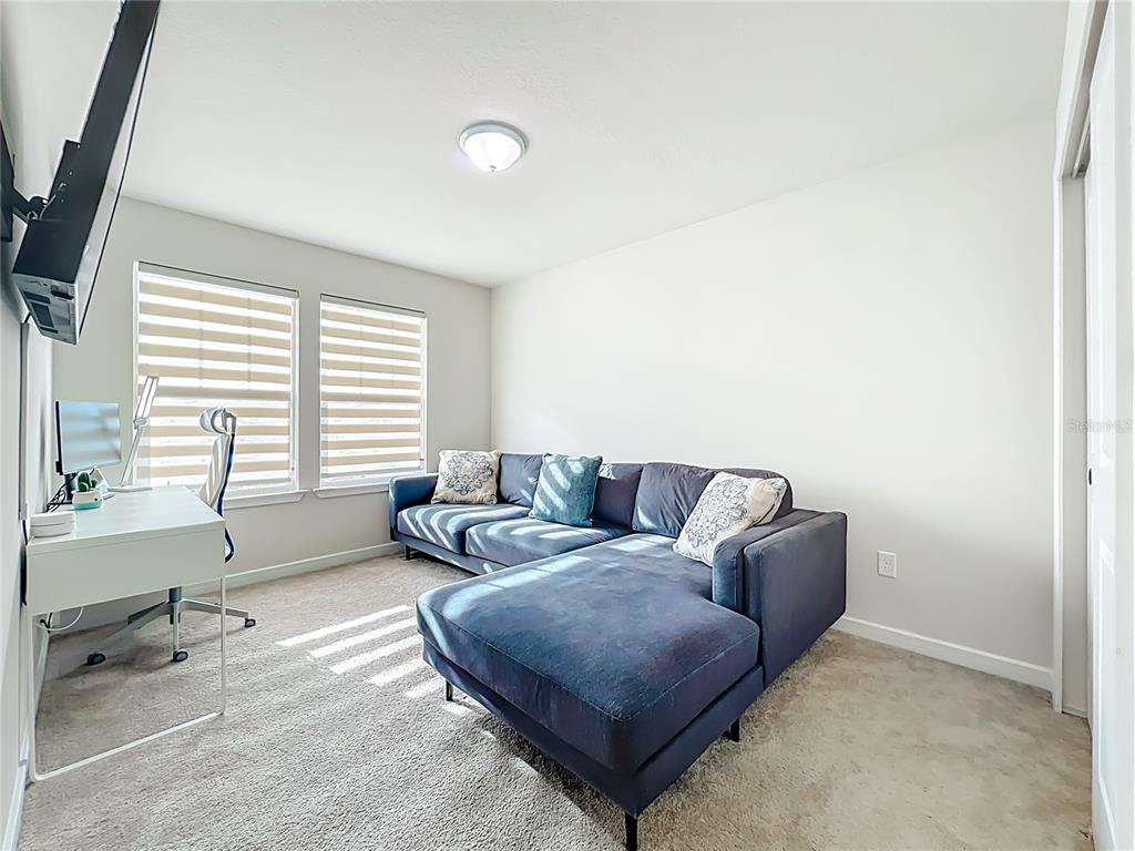 10976 Leafshore Loop Orlando, FL 32829 - Photo 35 of 70 a living room with furniture and a window