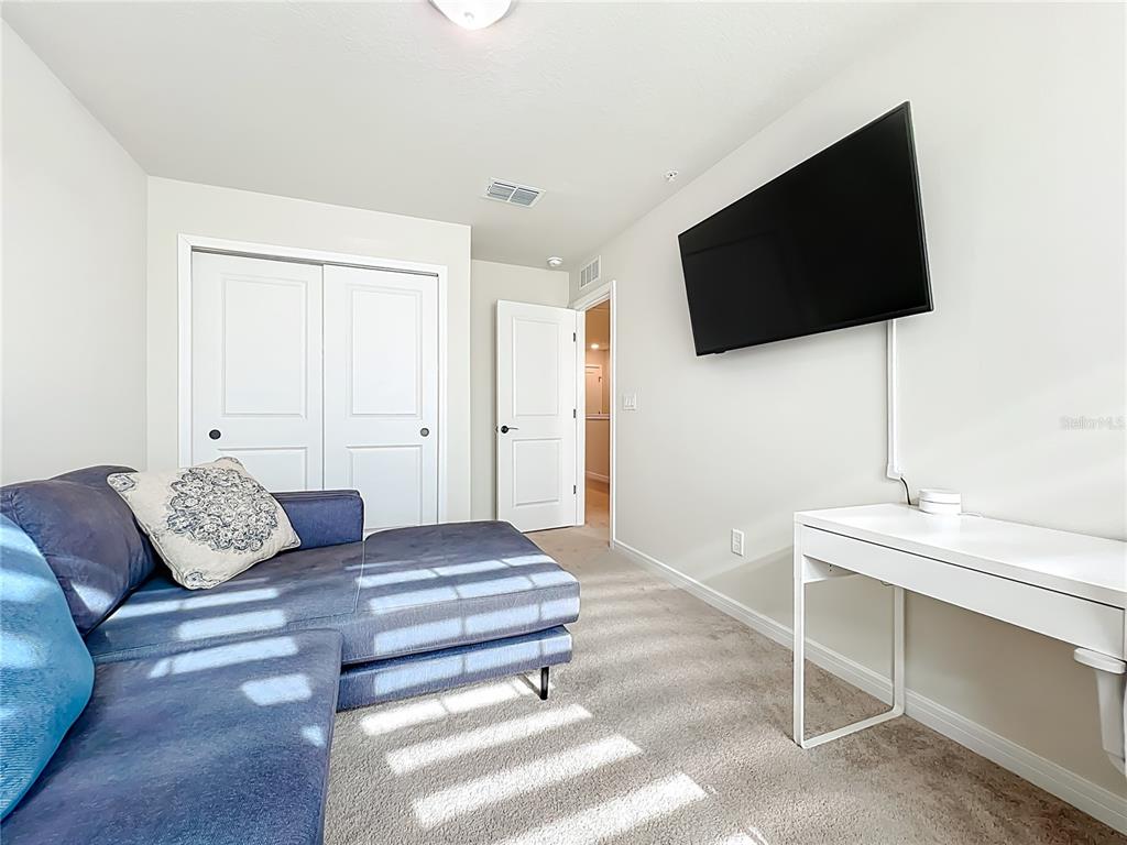 10976 Leafshore Loop Orlando, FL 32829 - Photo 36 of 70 a living room with furniture and a flat screen tv