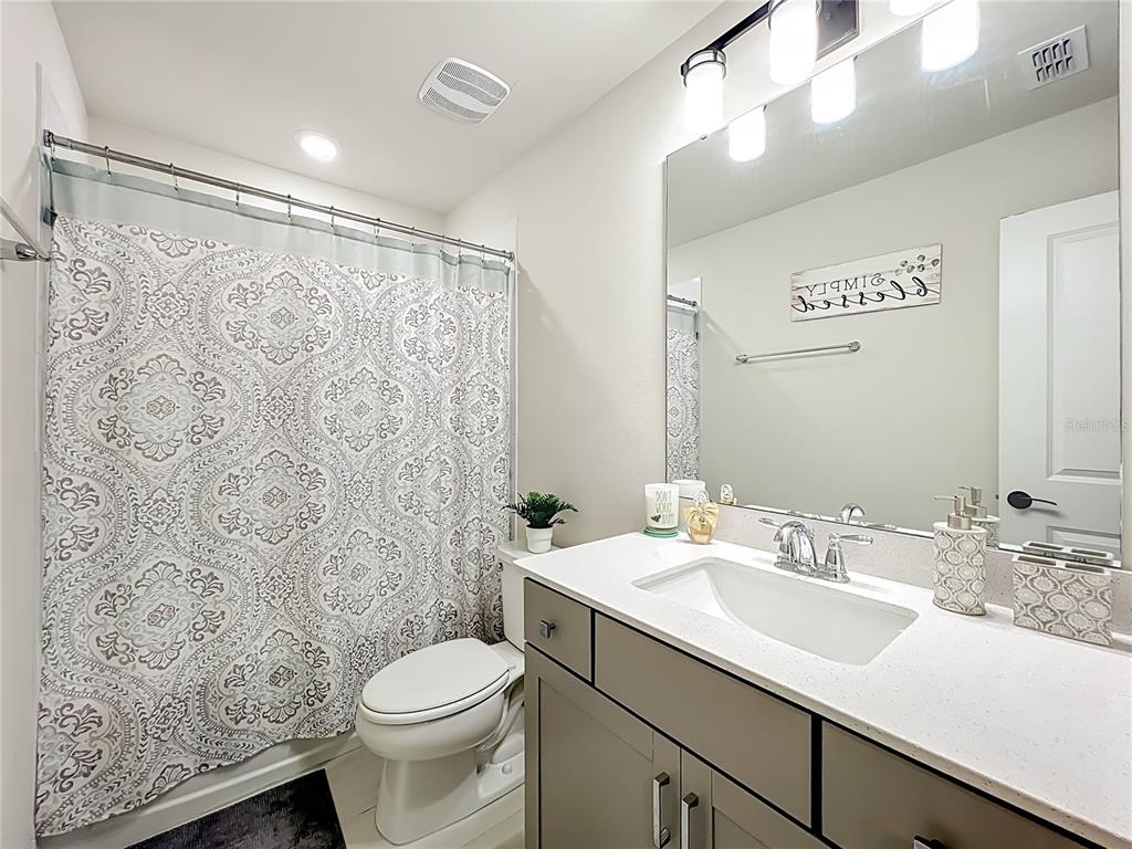 10976 Leafshore Loop Orlando, FL 32829 - Photo 39 of 70 a bathroom with a sink toilet and shower