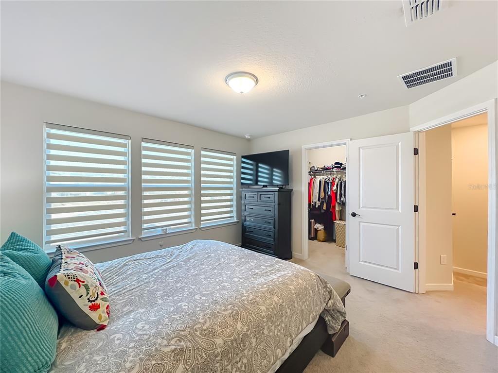 10976 Leafshore Loop Orlando, FL 32829 - Photo 41 of 70 a bedroom with a bed and a window