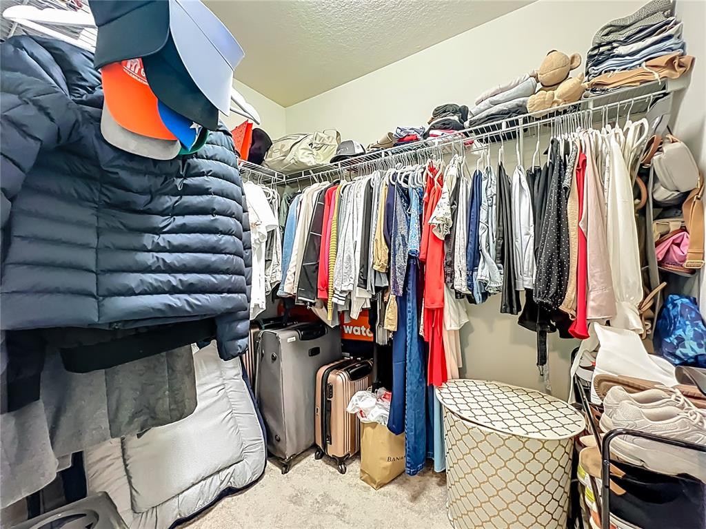 10976 Leafshore Loop Orlando, FL 32829 - Photo 45 of 70 a view of walk in closet with clothes and shoes