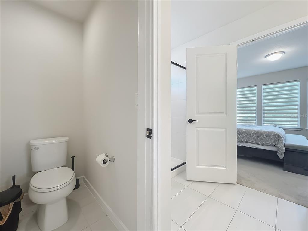 10976 Leafshore Loop Orlando, FL 32829 - Photo 48 of 70 a bathroom with a toilet a sink and a window