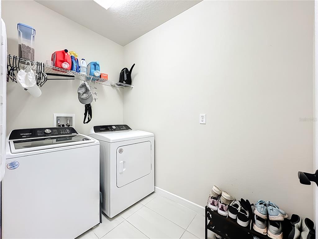 10976 Leafshore Loop Orlando, FL 32829 - Photo 51 of 70 a kitchen with a stove and cabinets