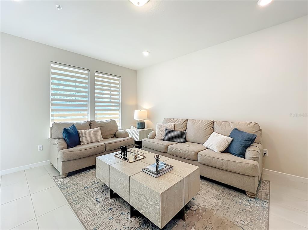 10976 Leafshore Loop Orlando, FL 32829 - Photo 10 of 70 a living room with furniture and a couch