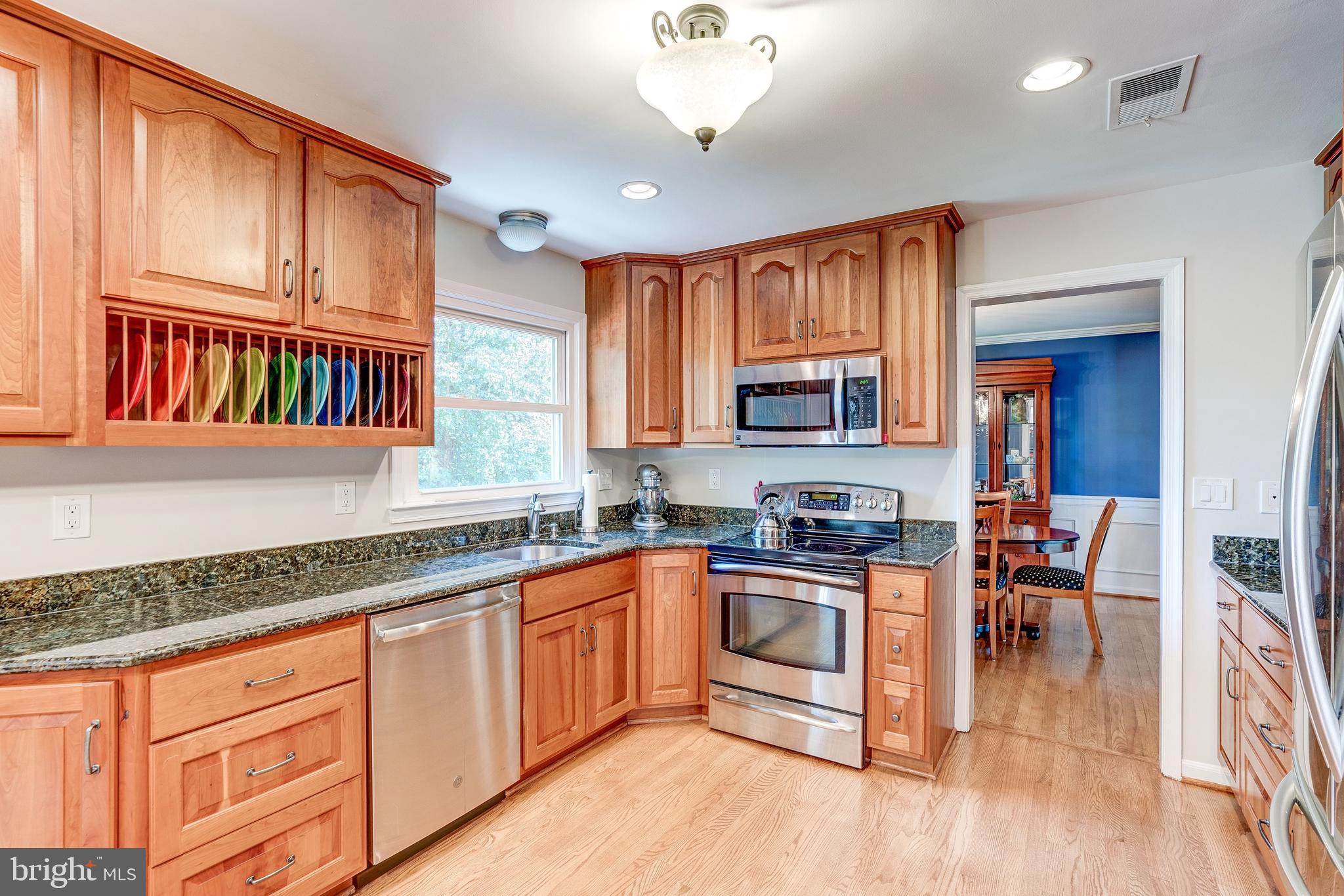 921 Riva Ridge Drive Great Falls, VA 22066 - Photo 12 of 44 renovated kitchen with wood floors, granite tops