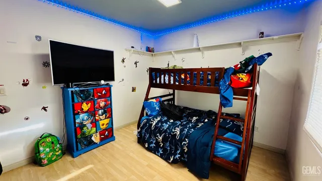 a bed room with furniture and a flat screen tv