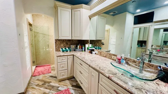 a kitchen with granite countertop a sink dishwasher stove and cabinets