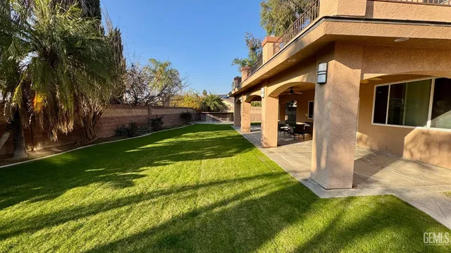 a bathroom with a granite countertop sink toilet and a mirror
