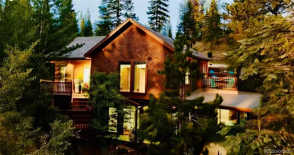 a view of house with outdoor space and sitting area