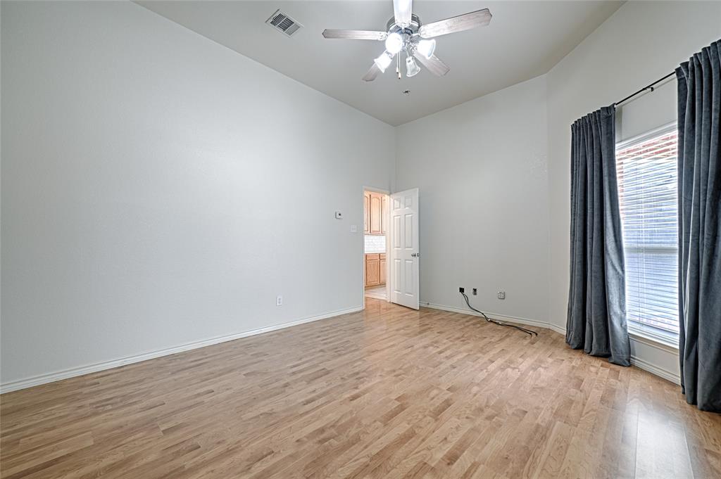 7681 Glasshouse Walk Frisco, TX 75035 - Photo 13 of 28 wooden floor in an empty room with a window