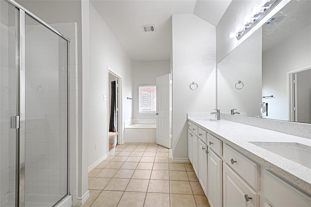 7681 Glasshouse Walk Frisco, TX 75035 - Photo 15 of 28 a spacious bathroom with a double vanity sink mirror and a bathtub