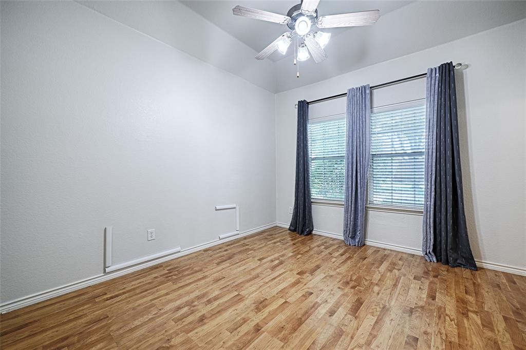 7681 Glasshouse Walk Frisco, TX 75035 - Photo 21 of 28 a view of an empty room with wooden floor and a window
