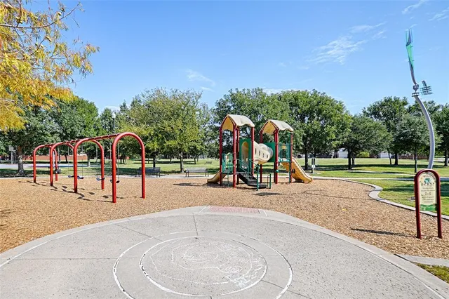 a view of a park with swings and slides