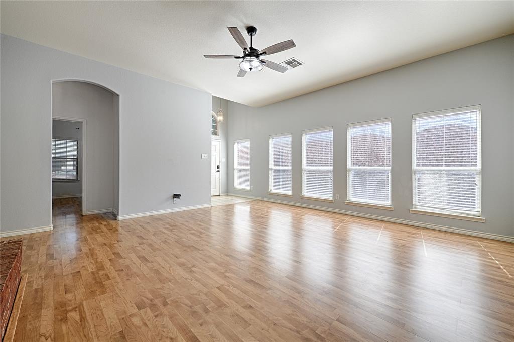 7681 Glasshouse Walk Frisco, TX 75035 - Photo 3 of 28 a view of an empty room with wooden floor and a window