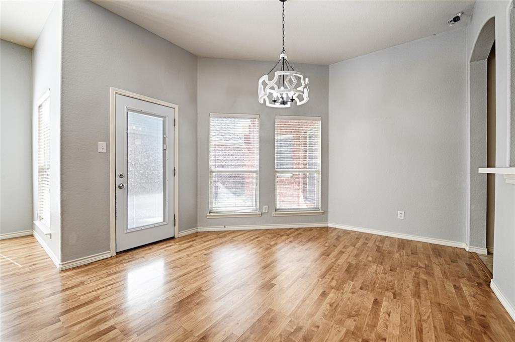 7681 Glasshouse Walk Frisco, TX 75035 - Photo 5 of 28 a view of an empty room with wooden floor and window