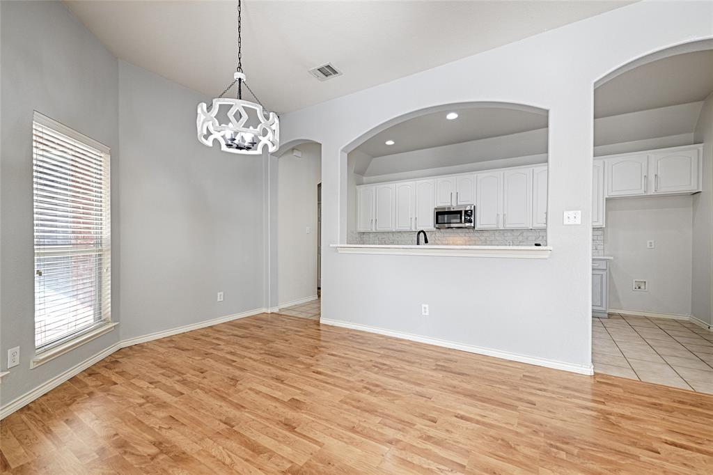7681 Glasshouse Walk Frisco, TX 75035 - Photo 6 of 28 a view of a room with wooden floor and kitchen view