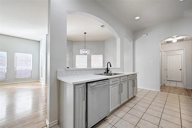 a kitchen with a sink and cabinets