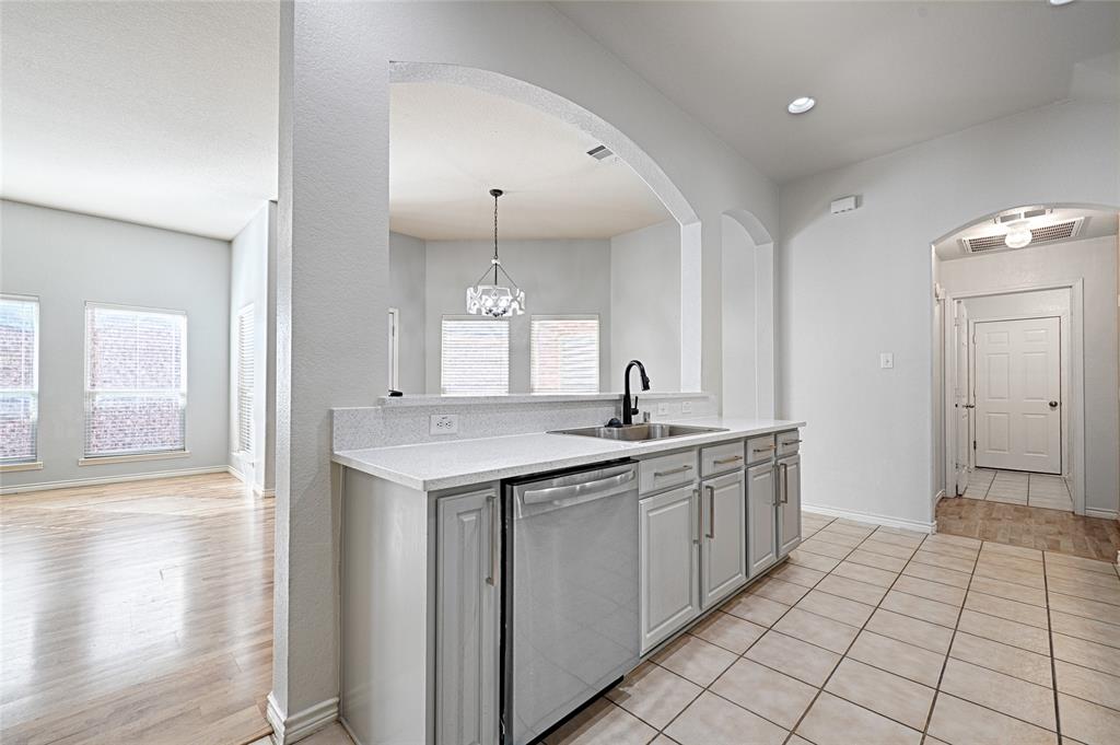 7681 Glasshouse Walk Frisco, TX 75035 - Photo 10 of 28 a kitchen with a sink and cabinets