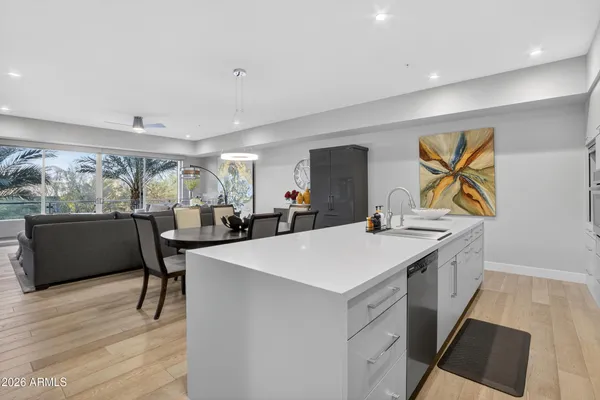 a large white kitchen with a large window