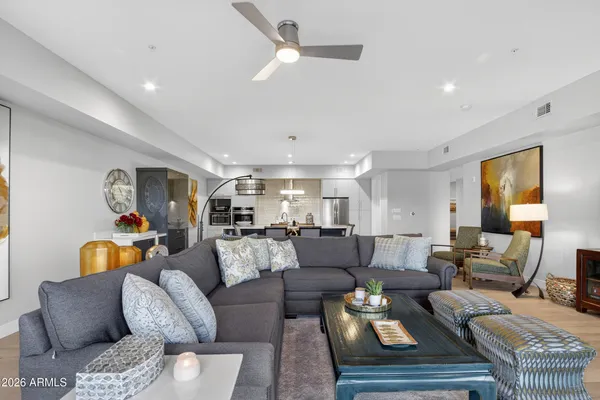 a living room with furniture or couch and a ceiling fan