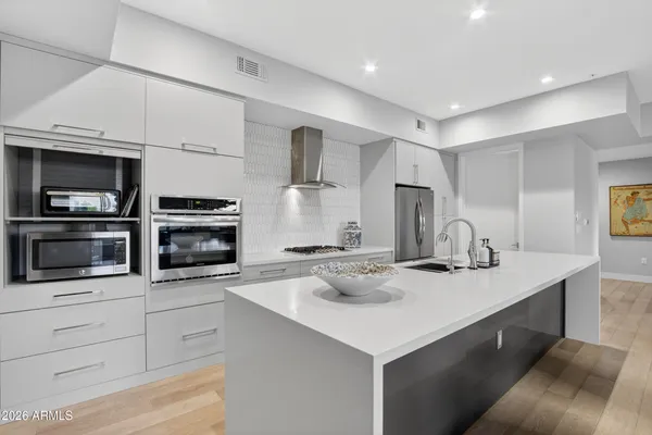 a kitchen with stainless steel appliances a stove microwave and cabinets