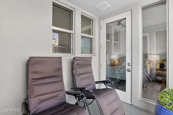 a view of a workspace with furniture and a window