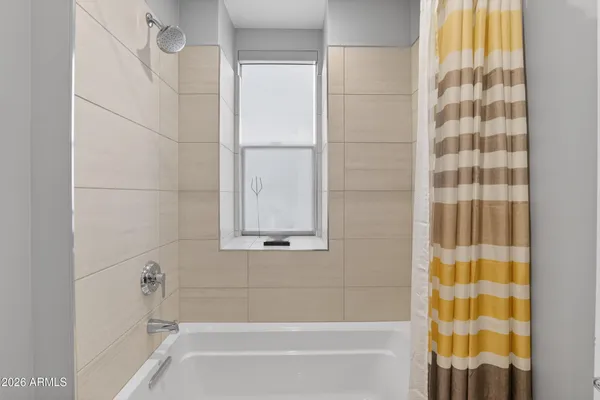 a bathroom with a bathtub and a shower