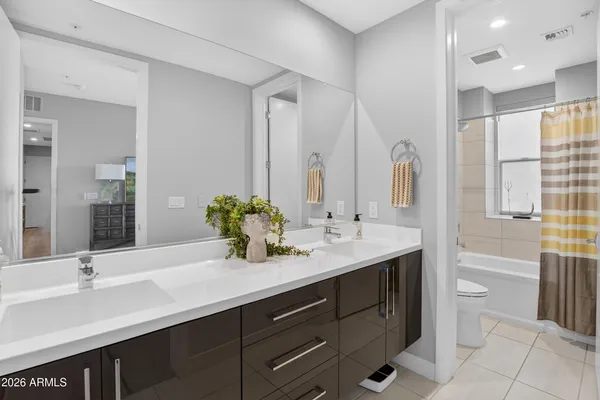 a bathroom with a double vanity sink mirror and toilet