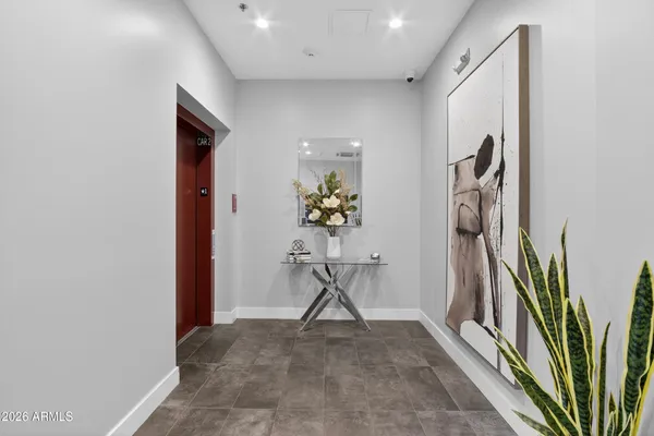 a view of a hallway with paintings on the wall