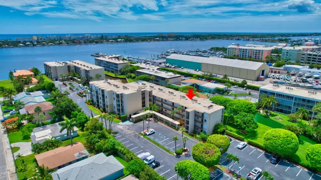 an aerial view of a house with outdoor space and lake view