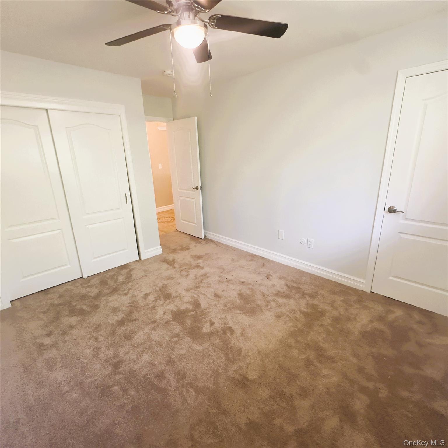 26 Cooper, Unit 603 Poughkeepsie, NY 12603 - Photo 11 of 15 an empty room with a ceiling fan and a window