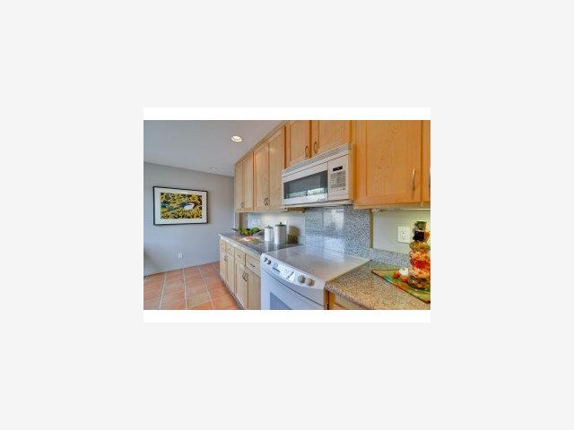 2040 West Middlefield Road, Unit 19 Mountain View, CA 94043 - Photo 3 of 9 a open kitchen with a sink and a painting on the wall