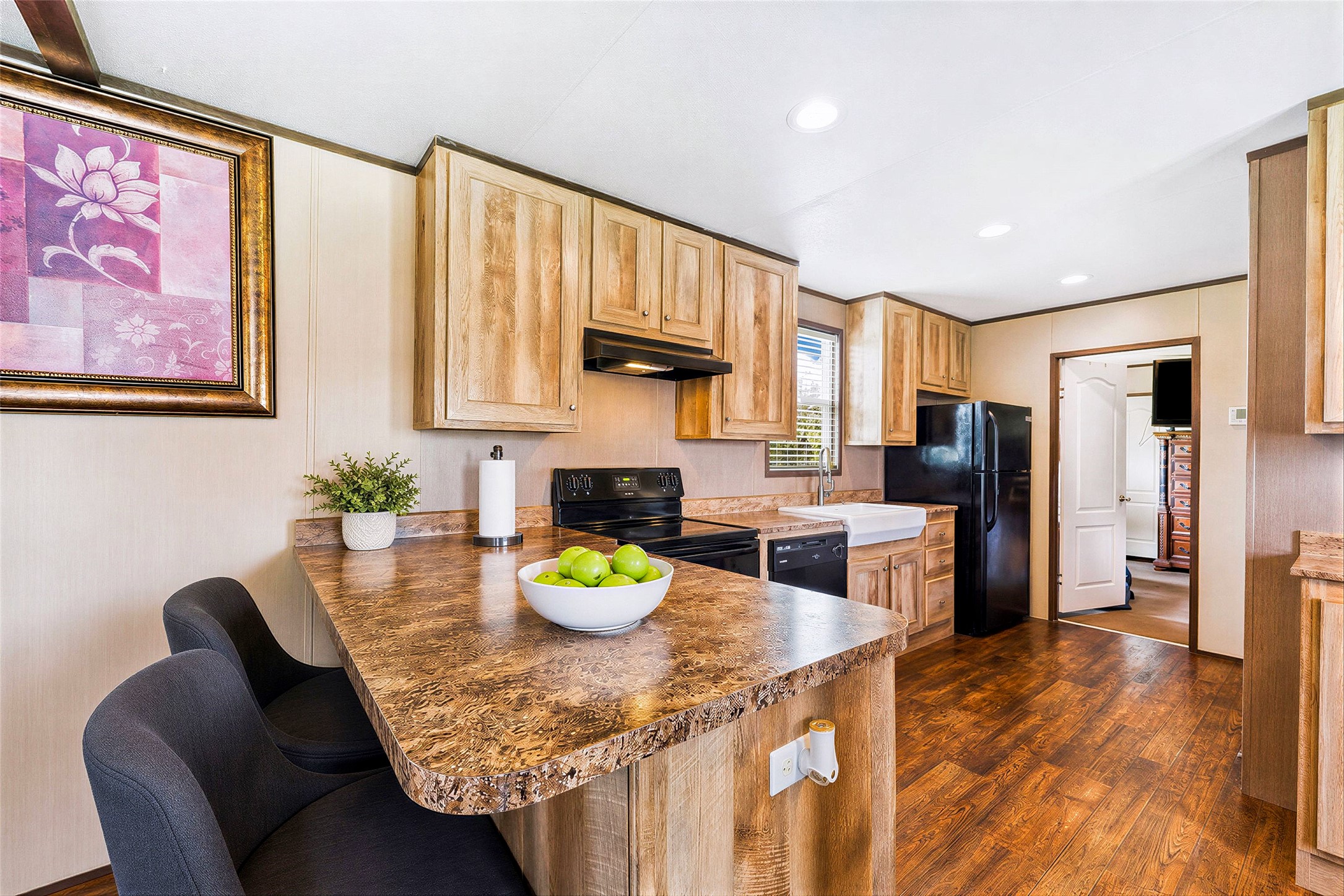 935 Lower Red Rock Road Bastrop, TX 78602 - Photo 6 of 25 Virtually staged - Kitchen featuring laminate flooring and a convenient breakfast bar.