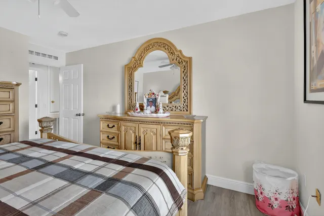 a bedroom with a bed and a mirror