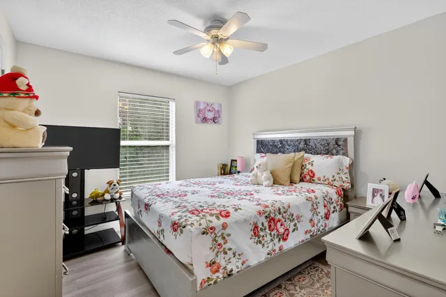 a bedroom with a bed and a chandelier