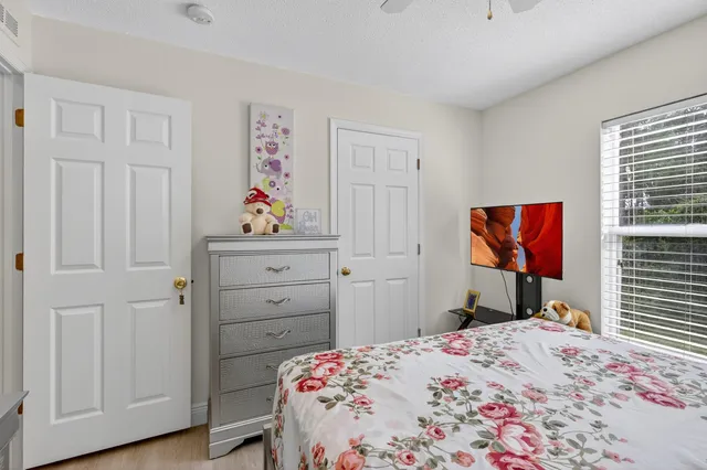 a bedroom that has a bed and a dresser in it