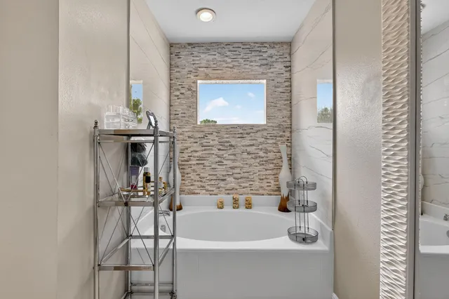 a bathroom with a bathtub and shower