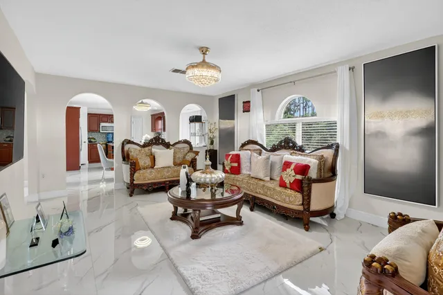 a living room with furniture and a chandelier