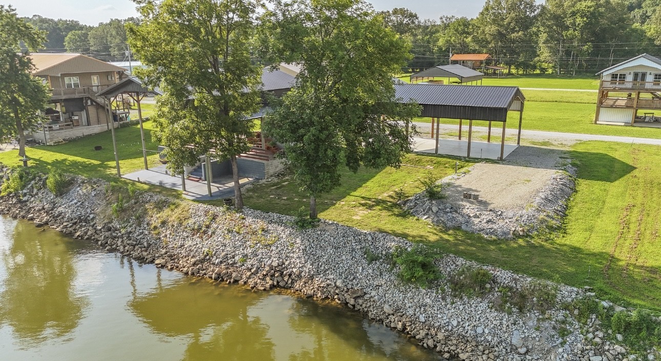 1085 WC PICKETT Road Clifton, TN 38425 - Photo 13 of 72 a view of a lake with a house in the background