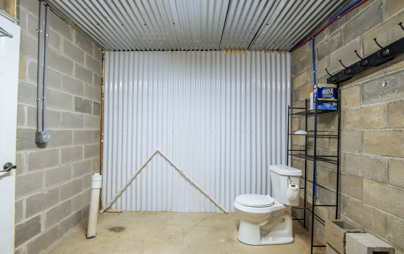 1085 WC PICKETT Road Clifton, TN 38425 - Photo 57 of 72 a bathroom with a toilet and a shower curtain